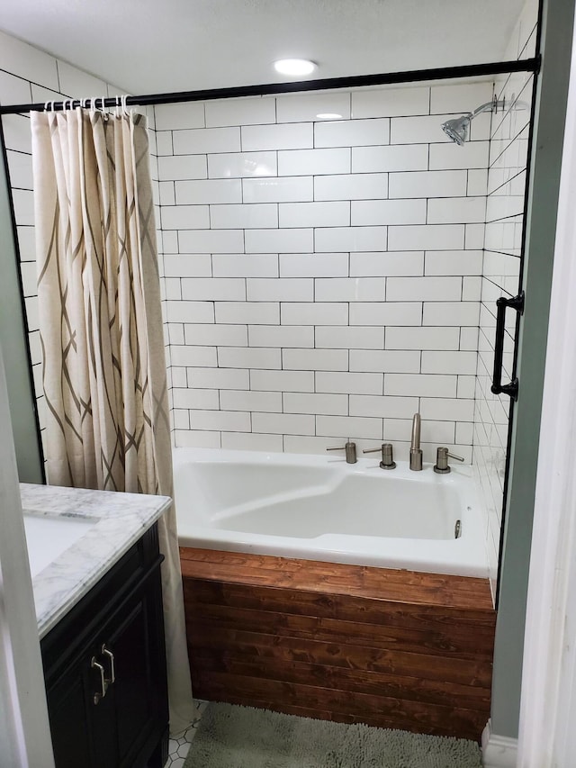 bathroom featuring shower / tub combo and vanity