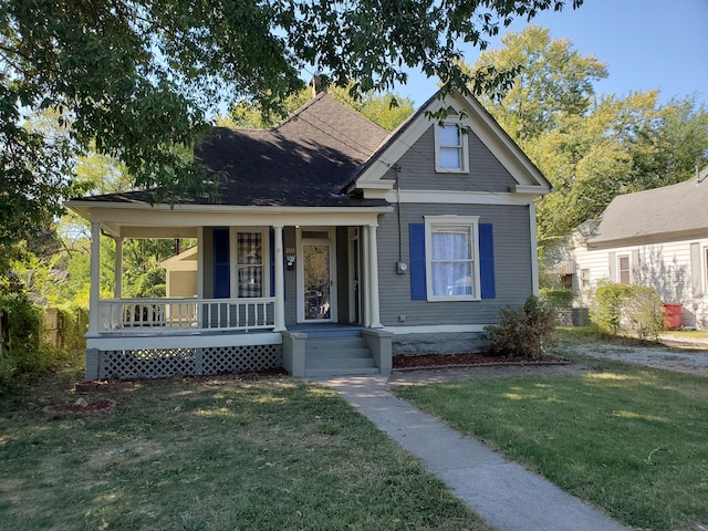 view of front facade featuring a front lawn and covered porch