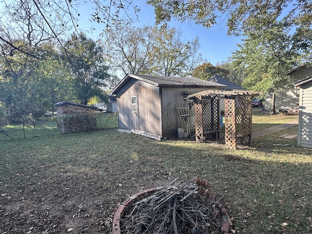 exterior space with a storage shed and a yard