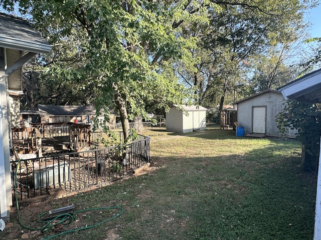 view of yard with a deck and a storage unit