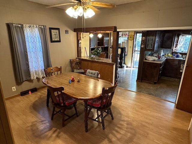 dining area with light hardwood / wood-style flooring and ceiling fan