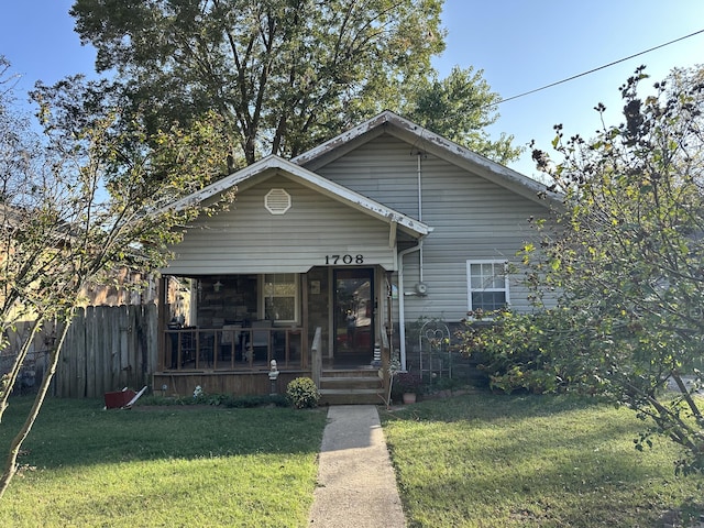 bungalow-style home featuring a front lawn