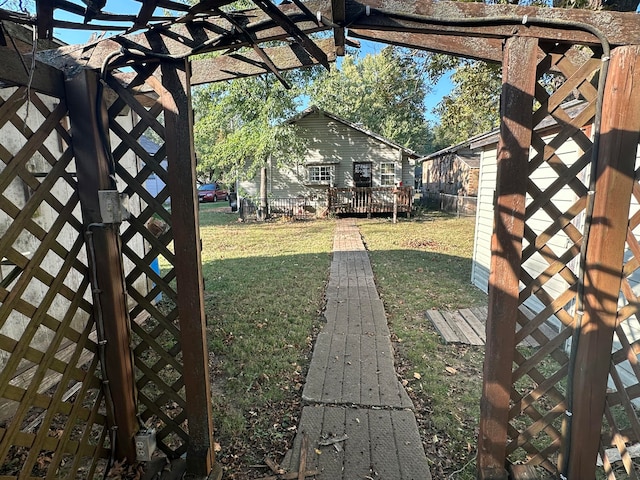 view of yard with a wooden deck and a pergola