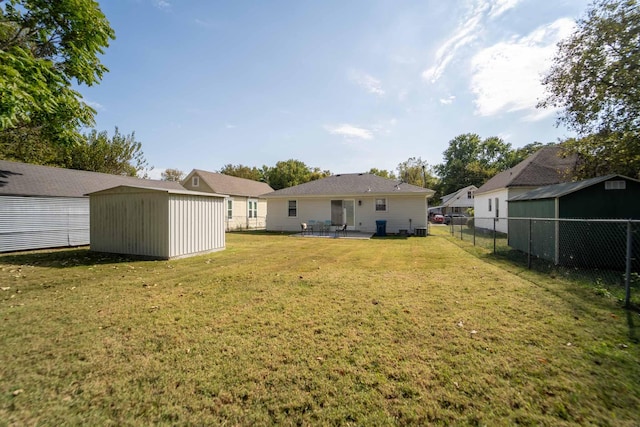 view of yard with a storage shed and a patio