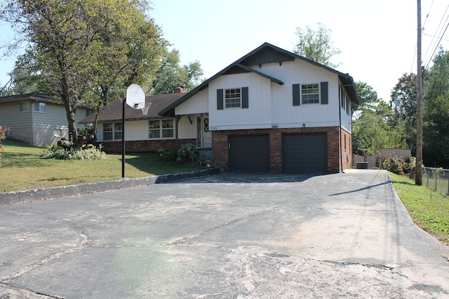 split level home with a garage and a front lawn