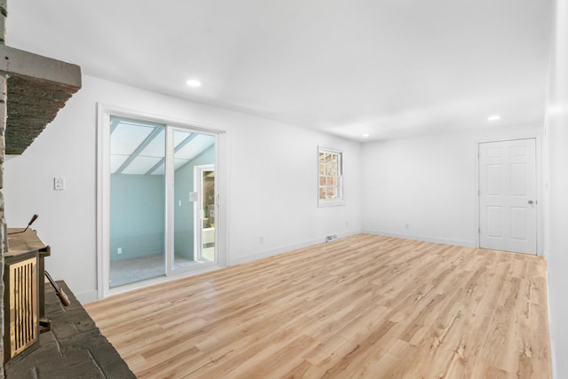 unfurnished living room featuring light hardwood / wood-style floors and a wealth of natural light