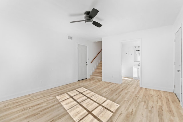 unfurnished living room featuring ceiling fan and light hardwood / wood-style flooring