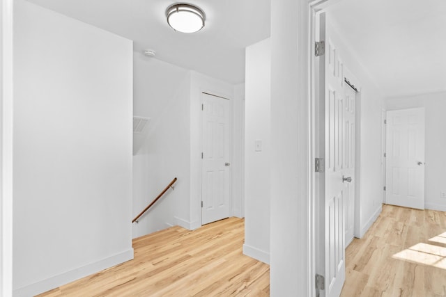 corridor with light wood-type flooring