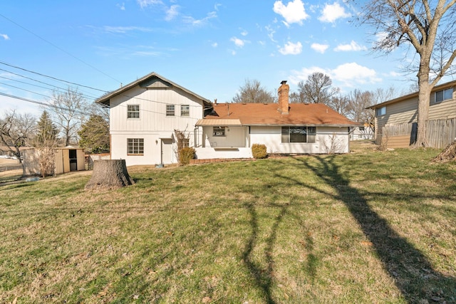 back of property featuring a lawn and a shed