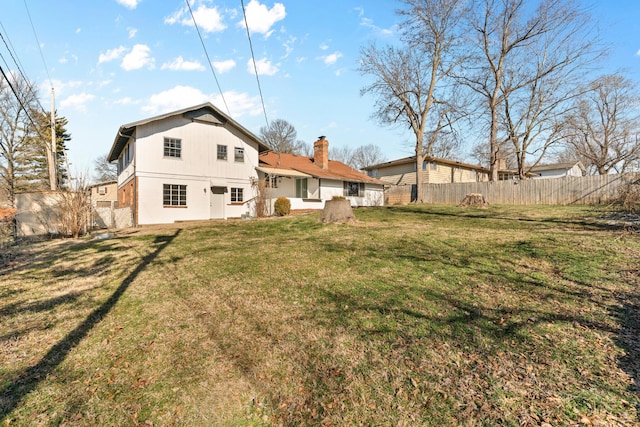 rear view of house with a yard