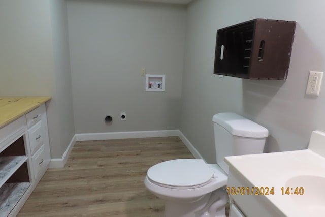 bathroom with hardwood / wood-style flooring, vanity, and toilet