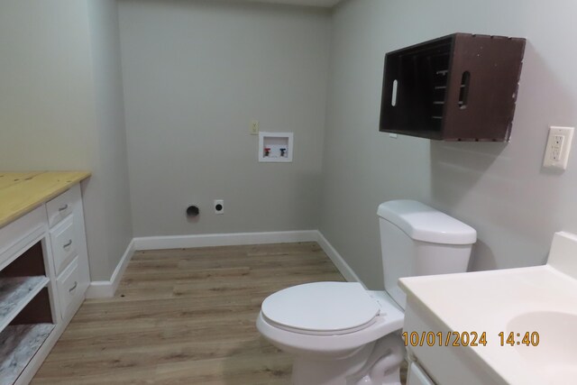 1504 S 14th Ave, Ozark, MO 65721 - half bath featuring baseboards, wood finished floors, toilet, and vanity