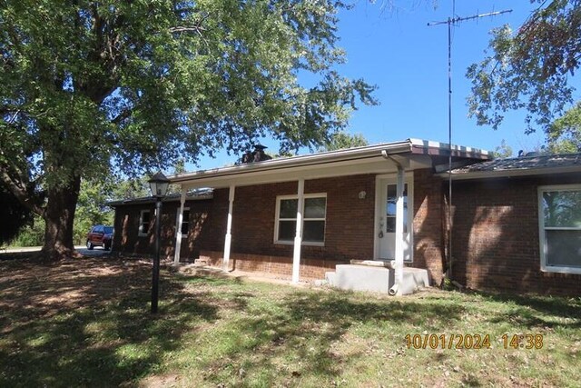 1504 S 14th Ave, Ozark, MO 65721 - exterior space featuring brick siding and a lawn