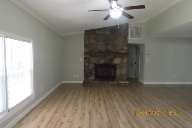 unfurnished living room featuring crown molding, vaulted ceiling, light hardwood / wood-style flooring, and ceiling fan