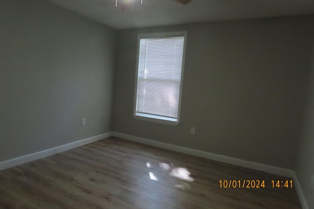 unfurnished room with ceiling fan and wood-type flooring