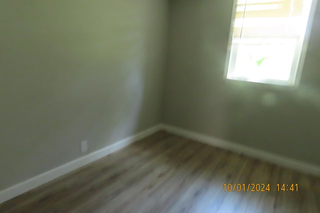 empty room with hardwood / wood-style flooring