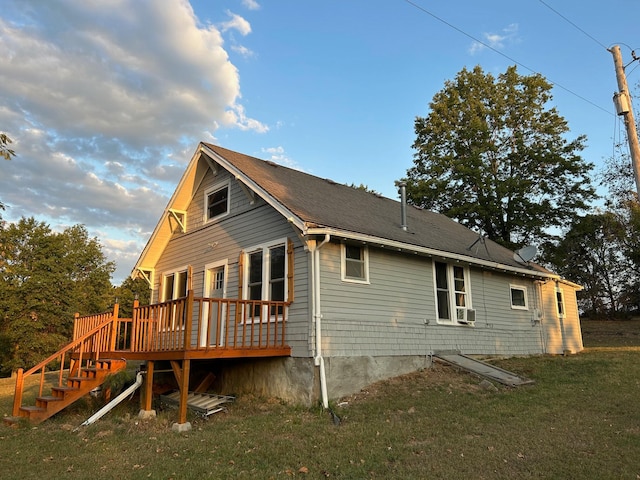 exterior space with cooling unit, a yard, and a deck