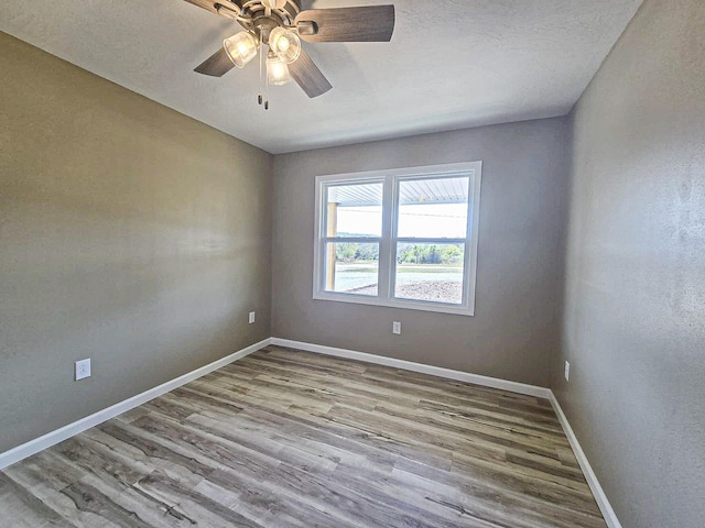 unfurnished room with ceiling fan and light hardwood / wood-style flooring