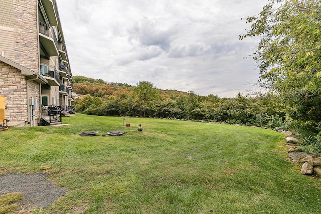 view of yard with a balcony