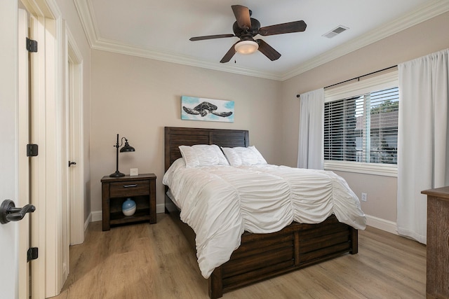 bedroom with crown molding, light wood-type flooring, and ceiling fan