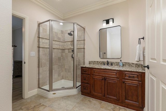 bathroom with ornamental molding, tile patterned floors, a shower with door, and vanity