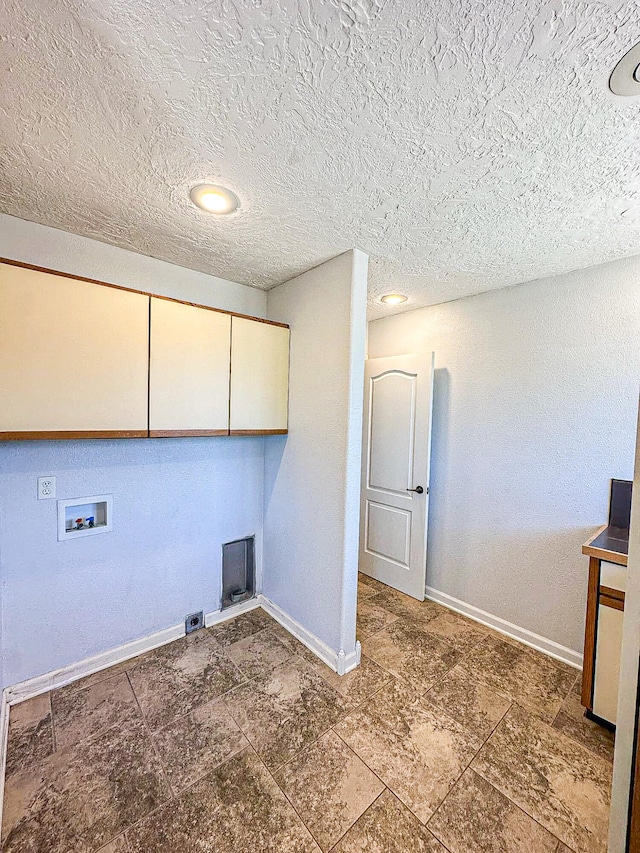 washroom featuring a textured ceiling, hookup for a washing machine, electric dryer hookup, and cabinets