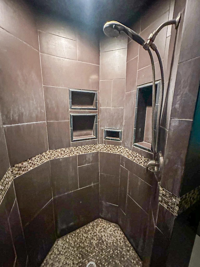 bathroom with tiled shower