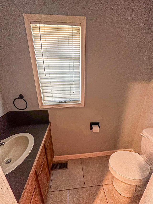 bathroom with vanity, toilet, and tile patterned floors