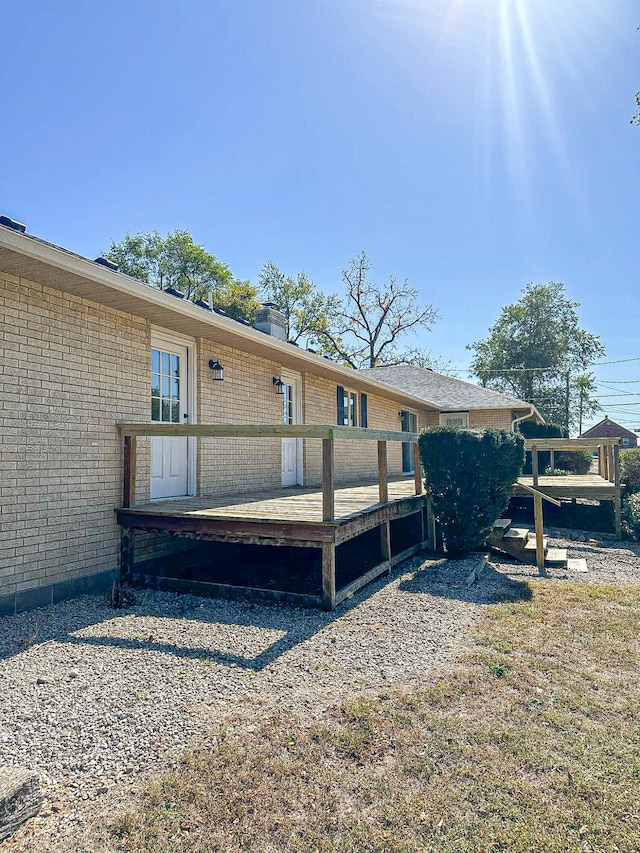 rear view of house featuring a deck