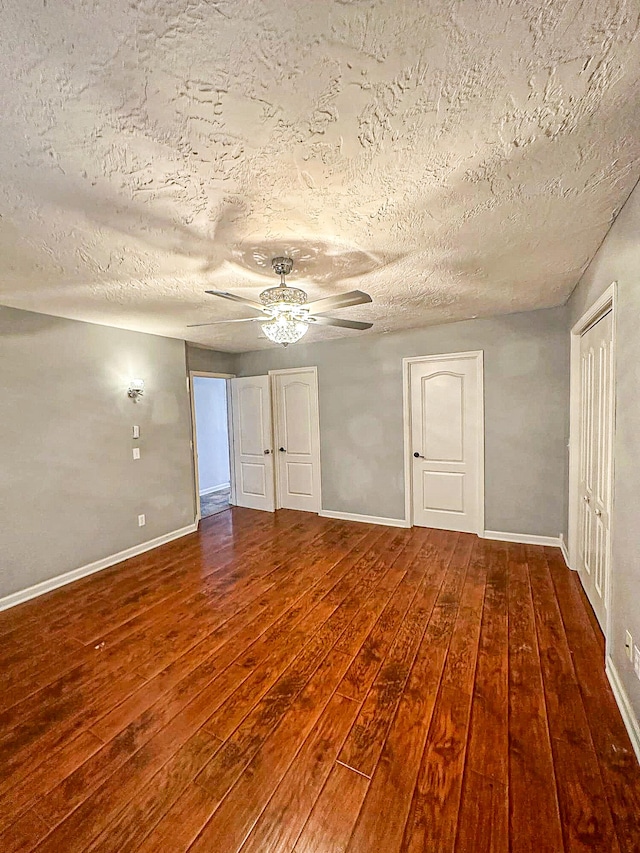 unfurnished bedroom featuring wood-type flooring, ceiling fan, and a textured ceiling