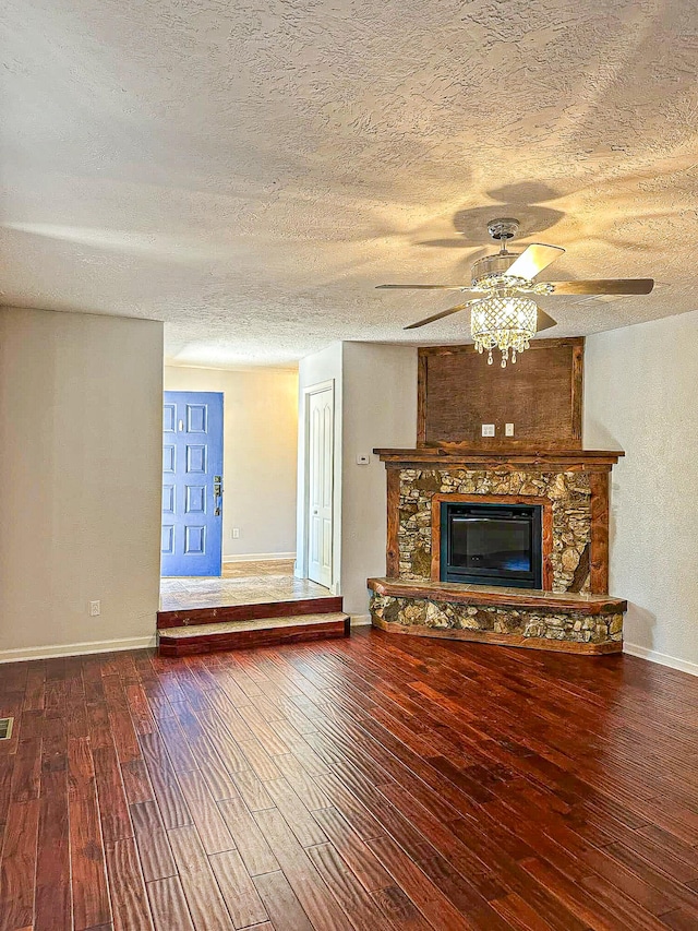 unfurnished living room with a textured ceiling, a fireplace, and hardwood / wood-style flooring