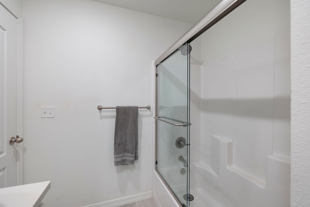 bathroom featuring vanity and shower / bath combination with glass door