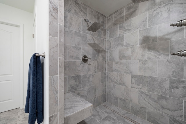 bathroom featuring a tile shower