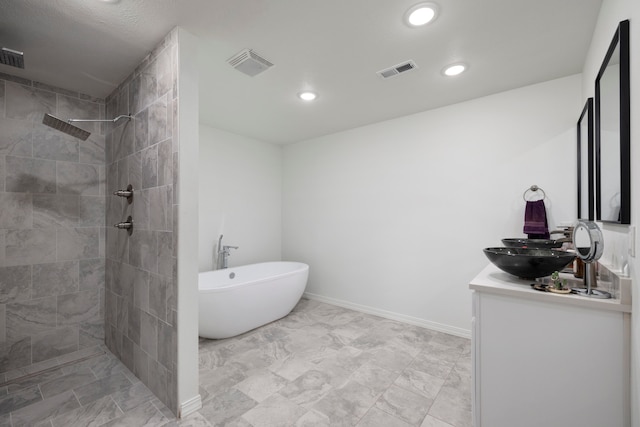 bathroom featuring vanity and plus walk in shower