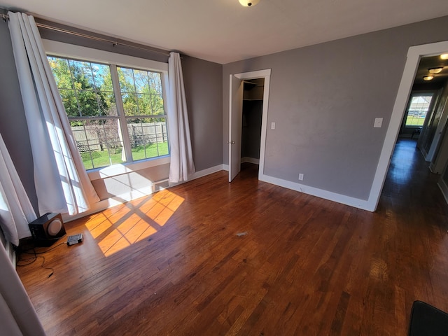 spare room with dark wood-type flooring