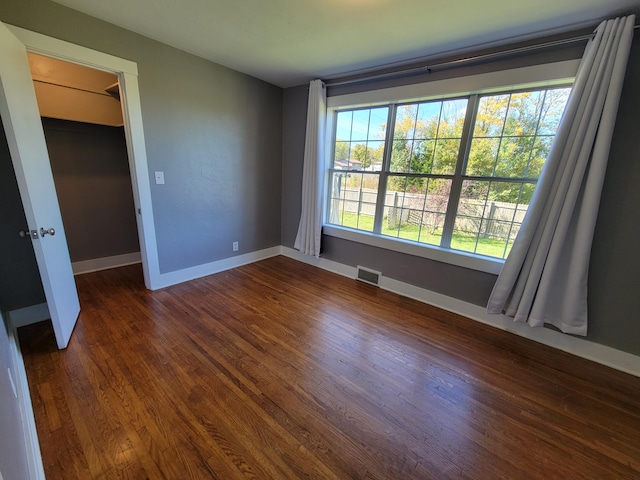 empty room featuring dark hardwood / wood-style flooring