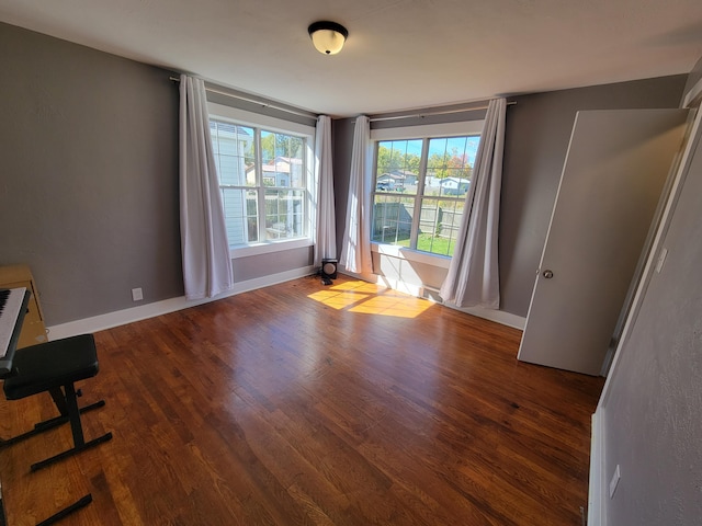 unfurnished room featuring dark wood-type flooring