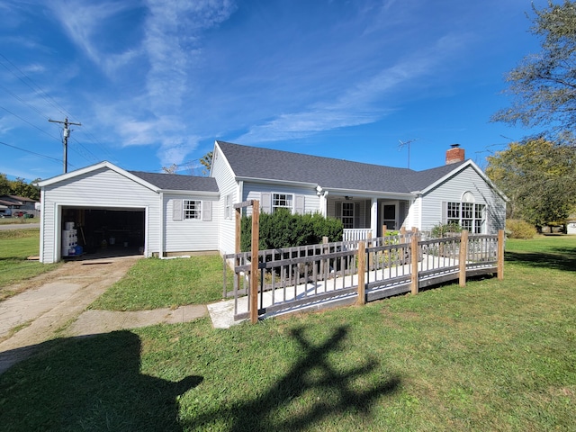 ranch-style house featuring an outbuilding, a deck, a front yard, and a garage