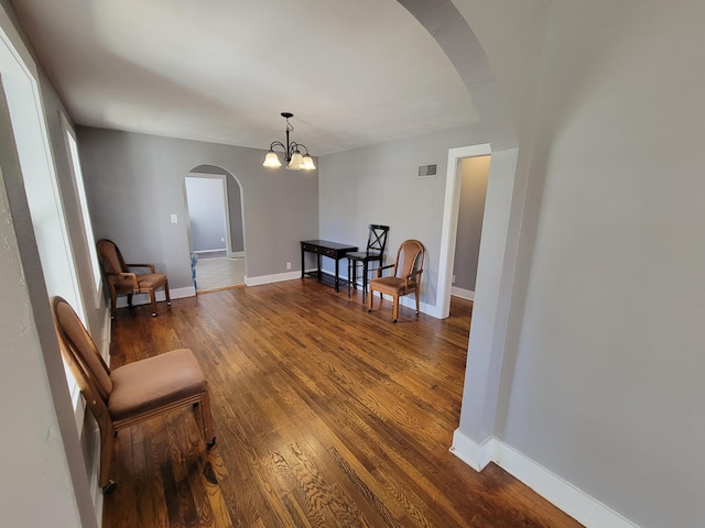 living area featuring a notable chandelier and hardwood / wood-style floors