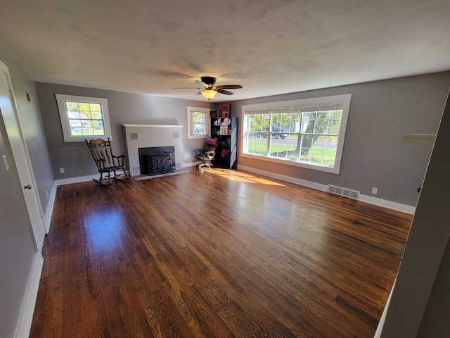 unfurnished living room with ceiling fan and dark hardwood / wood-style floors