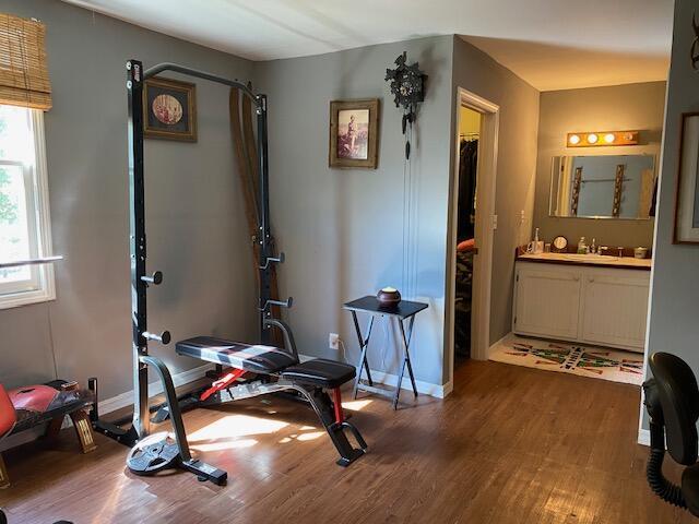 workout area with a wealth of natural light, wood finished floors, and baseboards