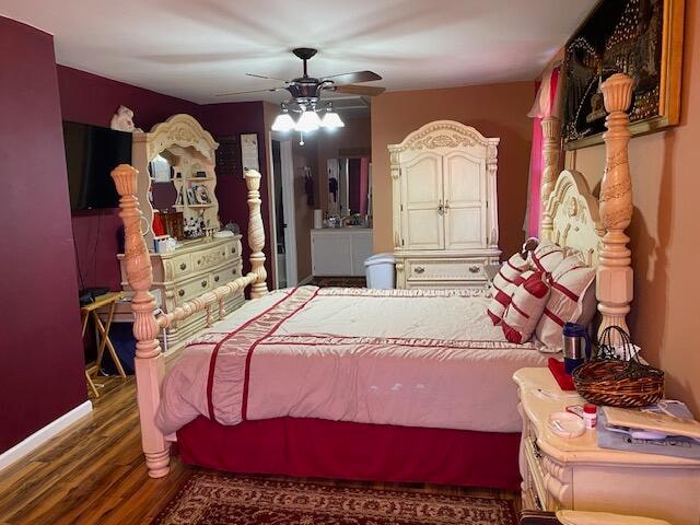 bedroom with dark hardwood / wood-style flooring and ceiling fan