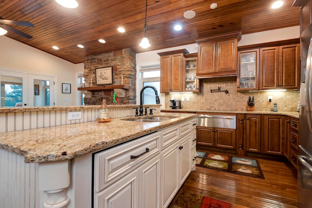 kitchen featuring a healthy amount of sunlight, white cabinetry, sink, and dark hardwood / wood-style flooring