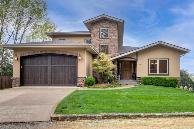 view of front of house with a garage and a front lawn