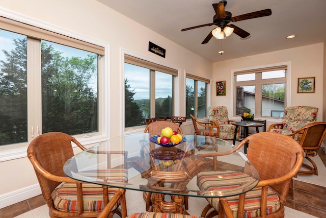 tiled dining space with ceiling fan