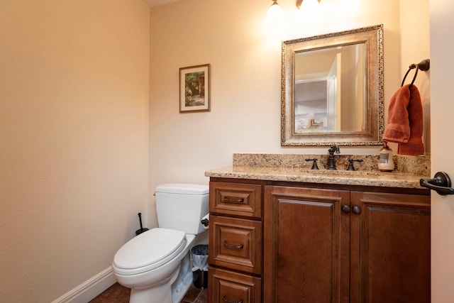 bathroom featuring vanity, tile patterned flooring, and toilet