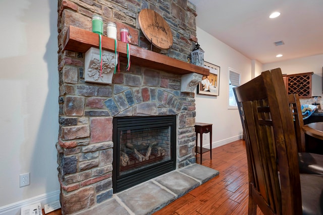 details with hardwood / wood-style flooring and a fireplace