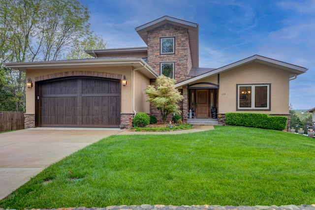 view of front of property featuring a garage and a front lawn