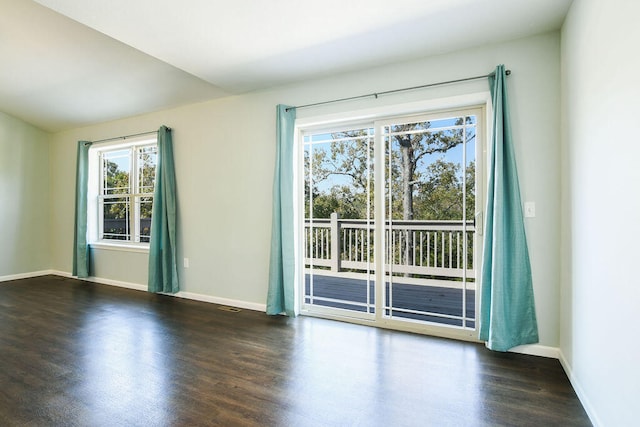 spare room with dark hardwood / wood-style floors