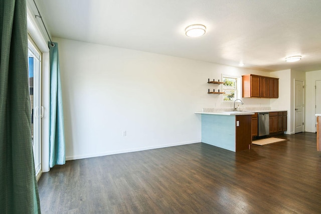 kitchen featuring dishwasher, kitchen peninsula, dark hardwood / wood-style floors, and sink